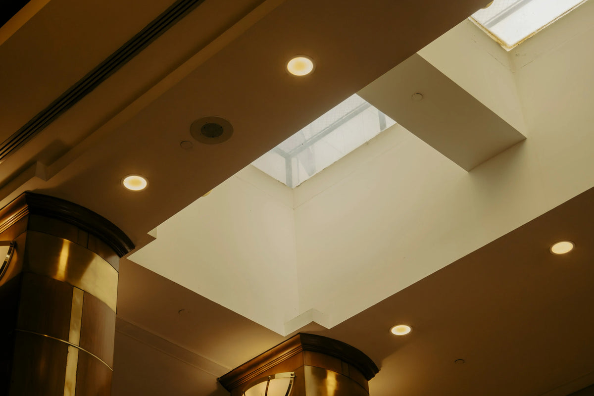 Ceiling with skylight and recessed lights in a building interior