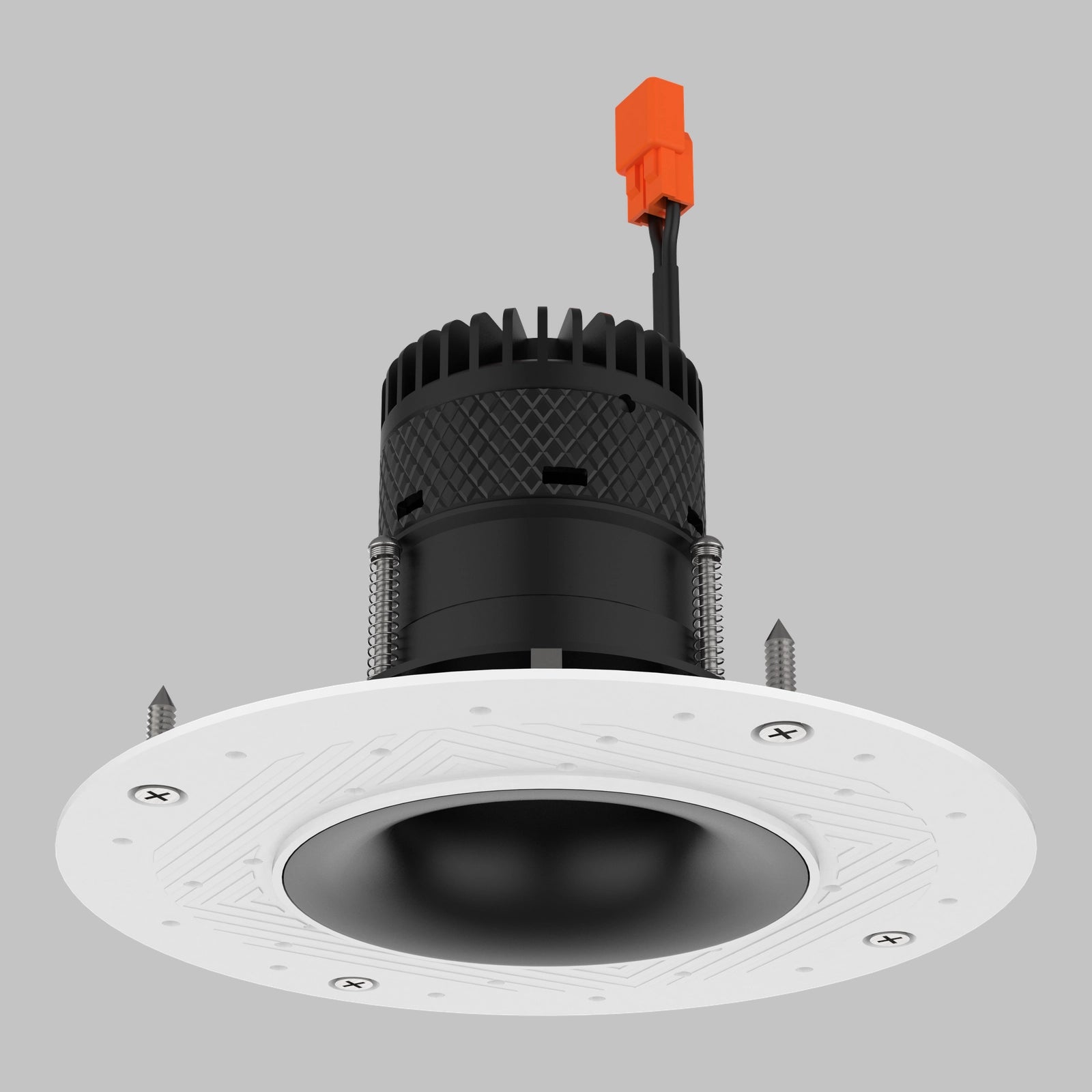 A recessed LED downlight fixture with a white circular mounting plate, a black ribbed heat sink body, and a small orange connector on the wire, shown against a solid gray background.#Shape + Color_Curved - Black#Trim Style_Trimless (Mud-In)