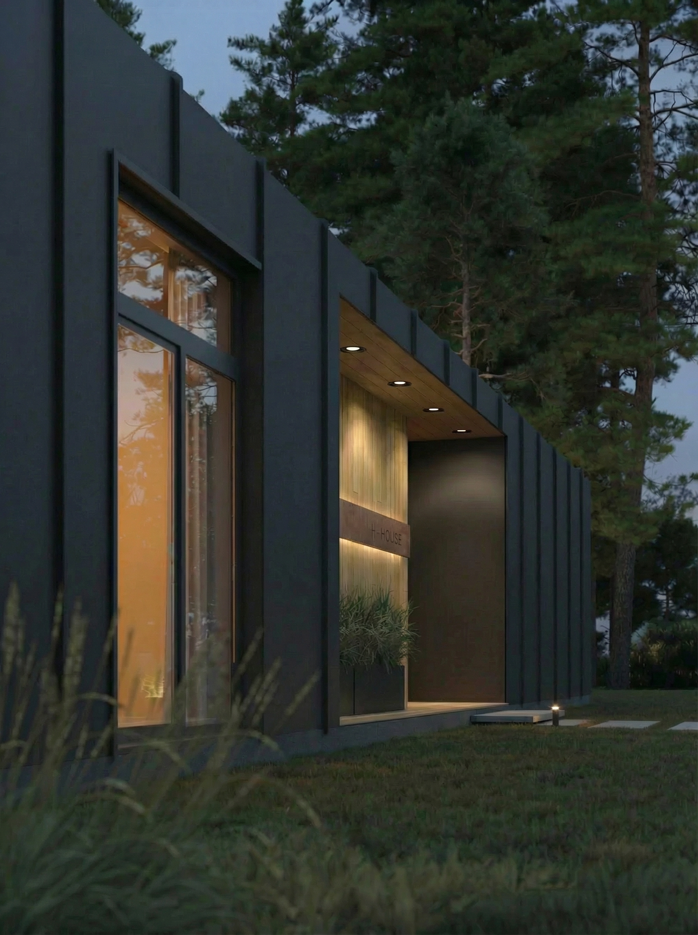 Modern house exterior with large windows at night, surrounded by trees.